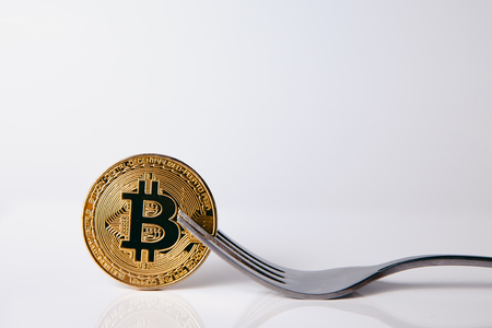 Bitcoin. Golden bitcoin with fork on white background, isolateの写真素材