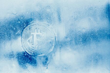 Bitcoin. Icon bitcoin on a blue ice frozen backgroundの写真素材