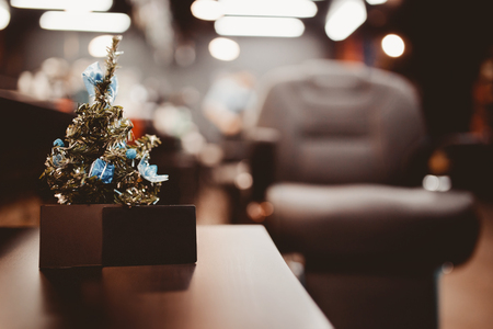Barbershop. Christmas tree with gifts on background of barber chair with business card. Concept Christmas, new year barber shopの写真素材