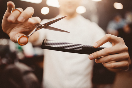 Barber shop. Close-up of barber holds clip-on hair clipper barbershopの写真素材