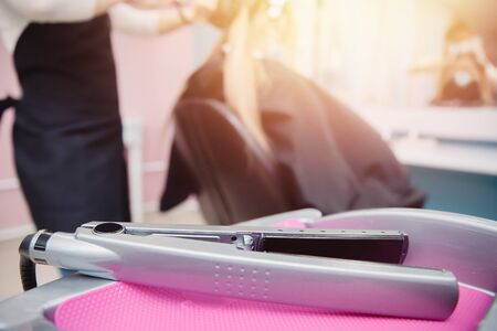 Interior hair. In foreground hair curler, in background hairdresserの写真素材