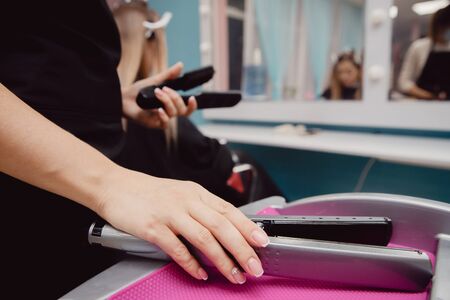Salon hair. In foreground hair curler, in background hairdresserの写真素材