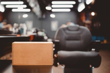 Barbershop. Box with gifts, in background barber chair. Place for your text. copyspaceの写真素材