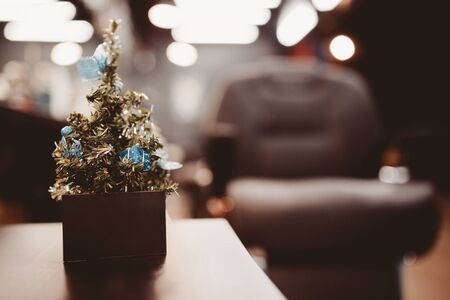 Barbershop. Christmas tree with gifts on background of barber chair with business card. Concept Christmas, new year barber shopの写真素材