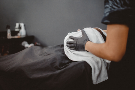 Barber Shop. The process of shaving, steam the face with a towel with steam in BarberShopの写真素材