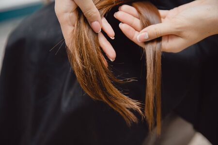 Comparison of healthy and broken, sick hair in a girl.の写真素材