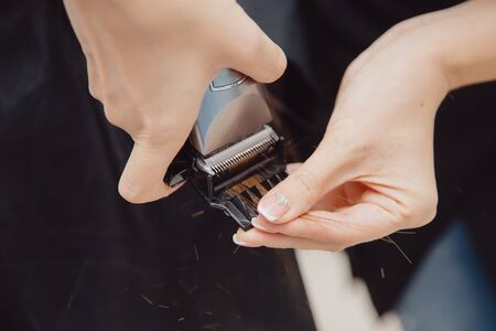 Salon hair. Hairdresser cuts torn hair endsの写真素材
