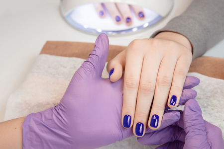 Manicure. Master Manicure nail paint pink colorの写真素材