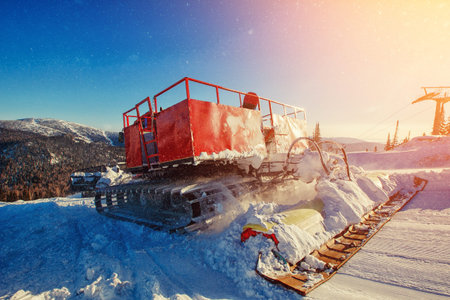 Snowcat trail bulldozer for skiers and snowboarders stands on background of mountains.Freeride snowboarding in Sheregesh ski resortの写真素材