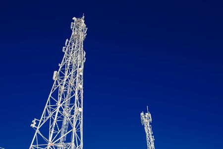 Cellular towers are icy with frost and cold, wires in the snow. abnormal frost, broken wires, winterの写真素材