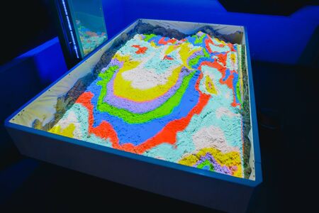 Kinetic sand. Simulator of the surface of the earth, mountains, hills, forest. The concept is to develop fine motor skills for children.の写真素材