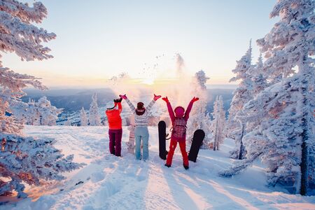 Happy team of snowboarders having fun tossing snow and fun.の写真素材