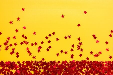 Confetti. Frame made of colored red star confetti. Copy spaceの写真素材