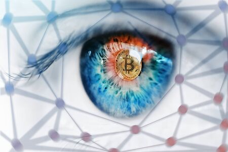 Bitcoin hardfork. Eye of a person with the bitcoin coin logo in pupil hard forkの写真素材