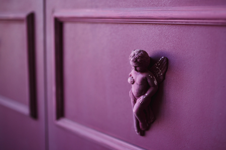 Figure of angel made of plaster and plaster on purple wall, loft style, decorの写真素材