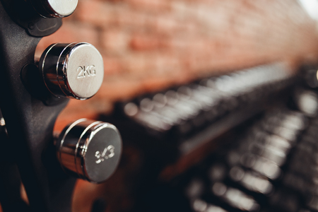Dumbbell. Rows of dumbbells in gym with loft modern gymの写真素材