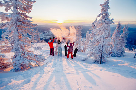Happy team of snowboarders having fun tossing snow and fun. Concept travel, ski resort, Freeride