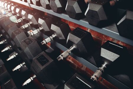 Dumbbell. Rows of dumbbells in gym with loft modern gymの写真素材