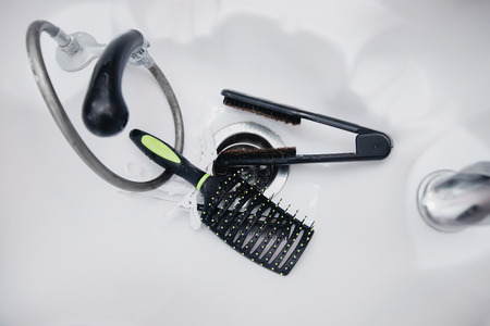 Tools for hair disinfection, cleaning in sink with water. View TOPの写真素材