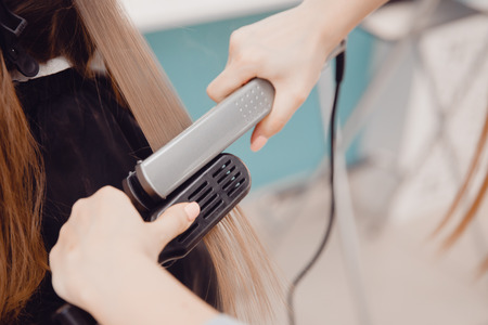 Master hair stylist makes hair restoration procedures. The keratin hair concept.の写真素材