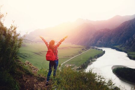 Girl traveler with backpack hiking. Concept travel, lifestyle adventure active summer vacations outdoor rocky background mountainsの写真素材