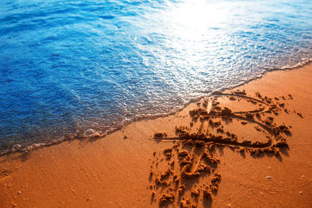 Bitcoin. Bitcoin on golden sand, in background sea. Concept collapse of bitcoin, soap bubble burst, freelance, stock exchange.の写真素材