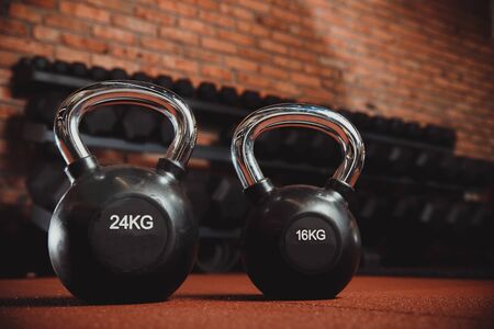 Close-up of weight for sports. dark background. 16 and 24 kilogramsの写真素材