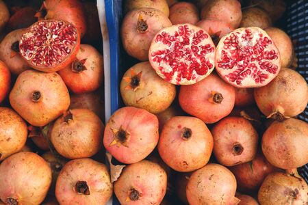 Pomegranate fruit. Fresh fruit lie in trunk of car, driven from plantationの写真素材