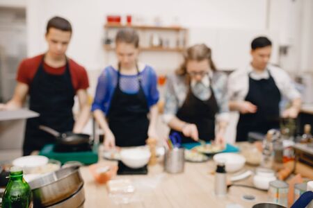 Blurred background, culinary master class, a group of people preparing a healthy mealの写真素材
