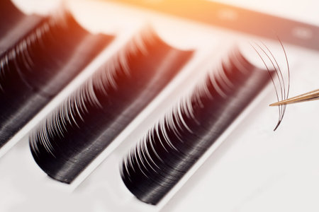 Eyelashes. Close-up tool for eyelash extension. Master of tweezers is working.