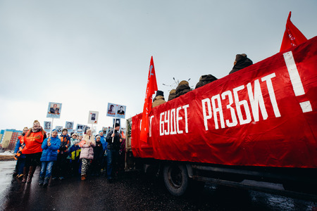 Murmansk, RUSSIA - MAY 9, 2017: Immortal regiment procession in Victory Day. Thousands of people marching to Square with flags and portraits in commemoration of soldiers of World War IIのeditorial素材