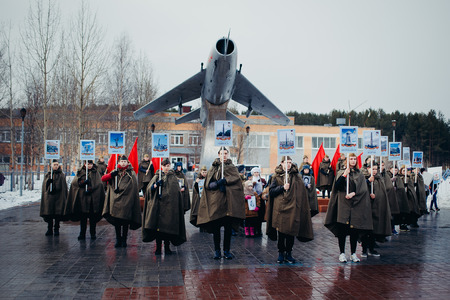 Murmansk, RUSSIA - MAY 9, 2017: Immortal regiment procession in Victory Day. Thousands of people marching to Square with flags and portraits in commemoration of soldiers of World War IIのeditorial素材