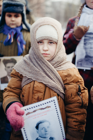 Murmansk, RUSSIA - MAY 9, 2017: Immortal regiment procession in Victory Day. Thousands of people marching to Square with flags and portraits in commemoration of soldiers of World War IIのeditorial素材