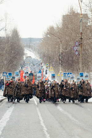Murmansk, RUSSIA - MAY 9, 2017: Immortal regiment procession in Victory Day. Thousands of people marching to Square with flags and portraits in commemoration of soldiers of World War IIのeditorial素材