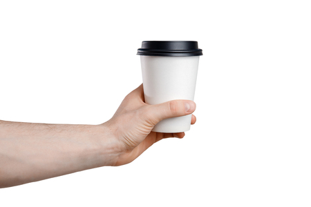 Mock up. Paper cup of coffee in hand. White paper cup of coffee in hand on Isolatedの写真素材
