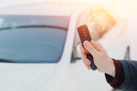 Key of car. Man holds car alarm key.の写真素材