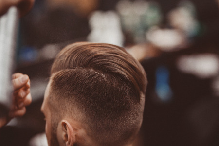 Barbershop. Hairdressers Barber puts the hair on the head of the man.の写真素材