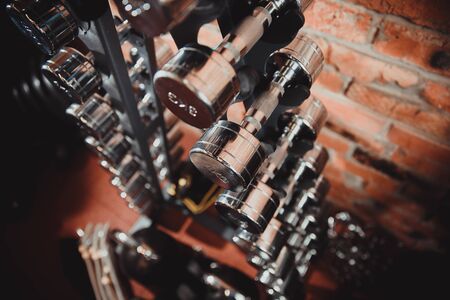 Rack with dumbbells of small scales, chrome, reflective and shiny coatingの写真素材