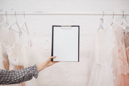 Copy space White modern wedding dresses in dress store.の写真素材