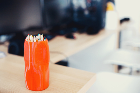 Workplace. Close-up of pencils in background series of computers in modern style.の写真素材