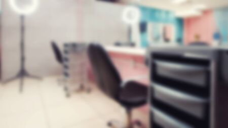 Blurred background a beauty salon, a workplace for a hairdresser, an armchair for clients.の写真素材