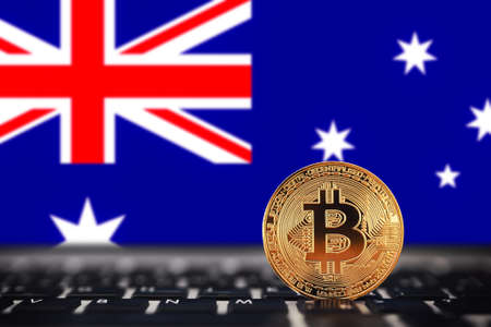 Gold Bitcoin on background of chart Australia flag.の写真素材