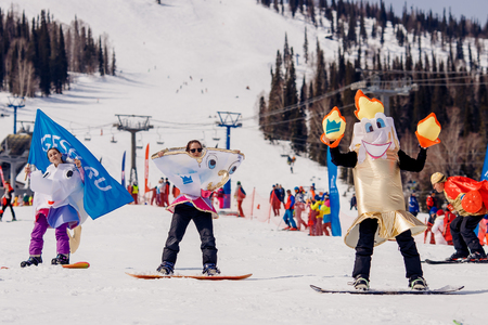 Sheregesh, Kemerovo, Russia - April 7, 2018: Grelka Fest: Group of people ski and snowboard riders in carnival costumes.のeditorial素材