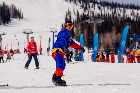 Sheregesh, Kemerovo, Russia - April 7, 2018: Grelka Fest: Group of people ski and snowboard riders in carnival costumes.のeditorial素材