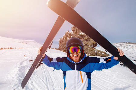 Selfie Guy sportsman goes on normal skiing on ski slope with action camera.の写真素材