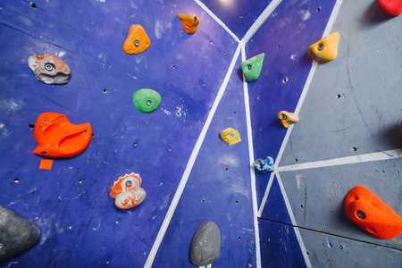 Close-up of hooks for rock climber on wall. Multicolored background.の写真素材