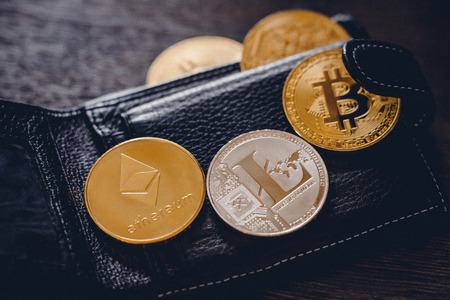 litecoin, ethereum, Gold Bitcoin against background of black wallet, concept of crypto currency.の写真素材