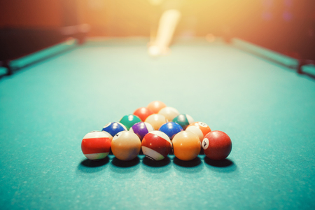 Balls for billiards snooker are triangle, man smashes cueの写真素材