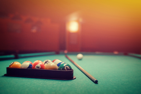 Balls for billiards pool snooker are on green table, preparation for gameの写真素材