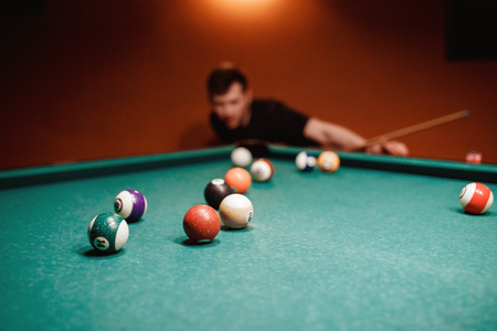 Balls for billiards snooker are triangle, man smashes cueの写真素材
